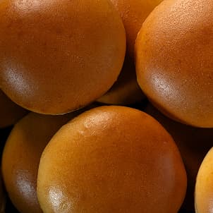 A stack of round brioche-style buns